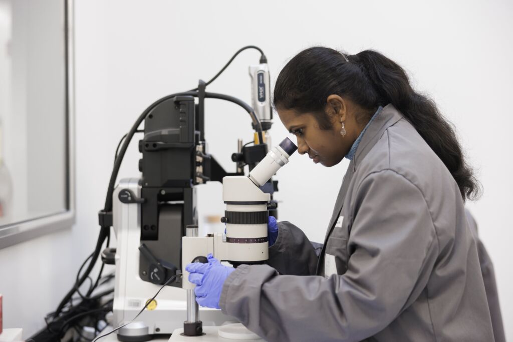 Scientist looking into Microscope